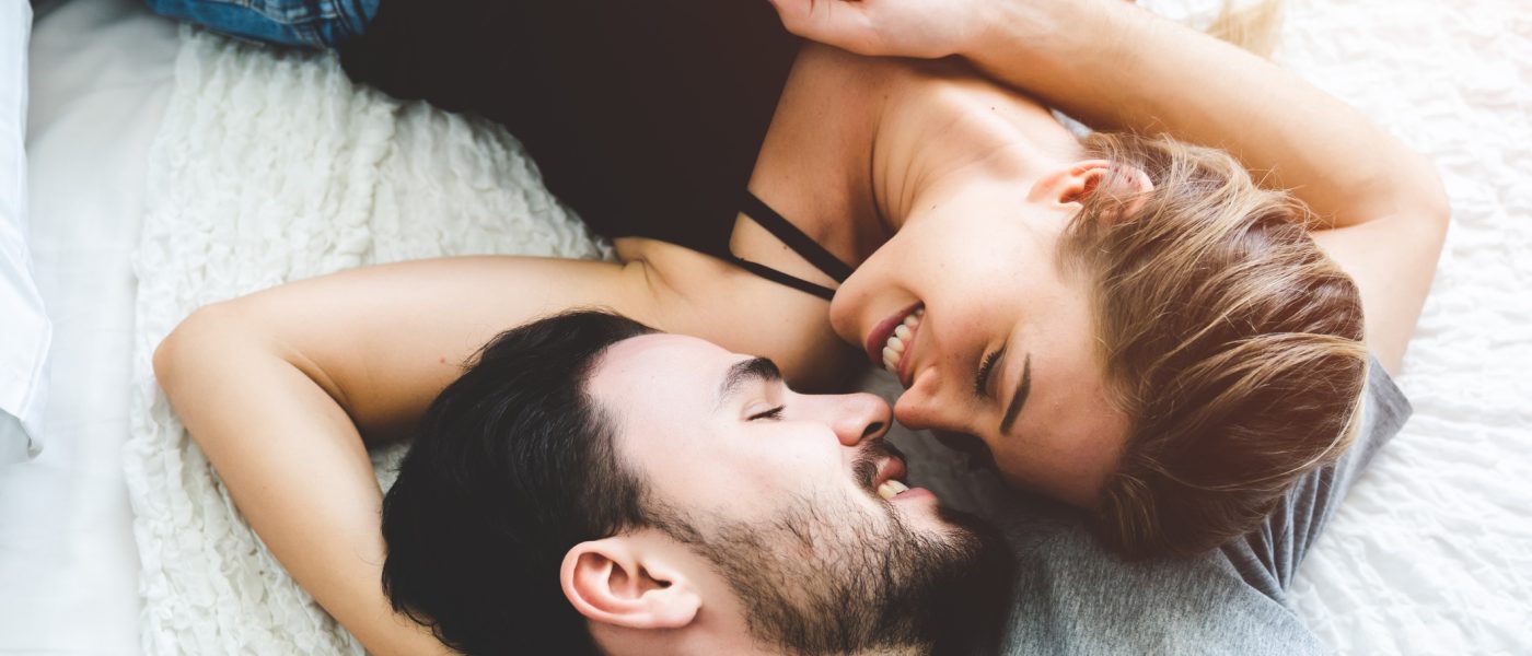 Passionate woman gently kissing man on with romantic kiss.desire lying on bed, young tender lover enjoys touching soft skin of sensual sexy lady moaning having sex.