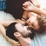 Passionate woman gently kissing man on with romantic kiss.desire lying on bed, young tender lover enjoys touching soft skin of sensual sexy lady moaning having sex.